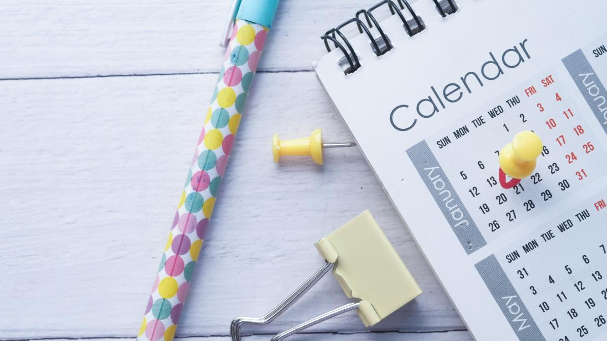Close up of calendar and office supplies on desk
