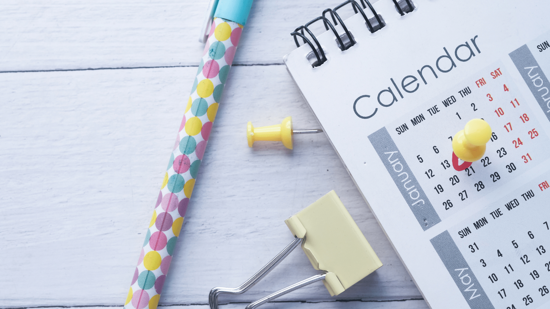 Close up of calendar and office supplies on desk