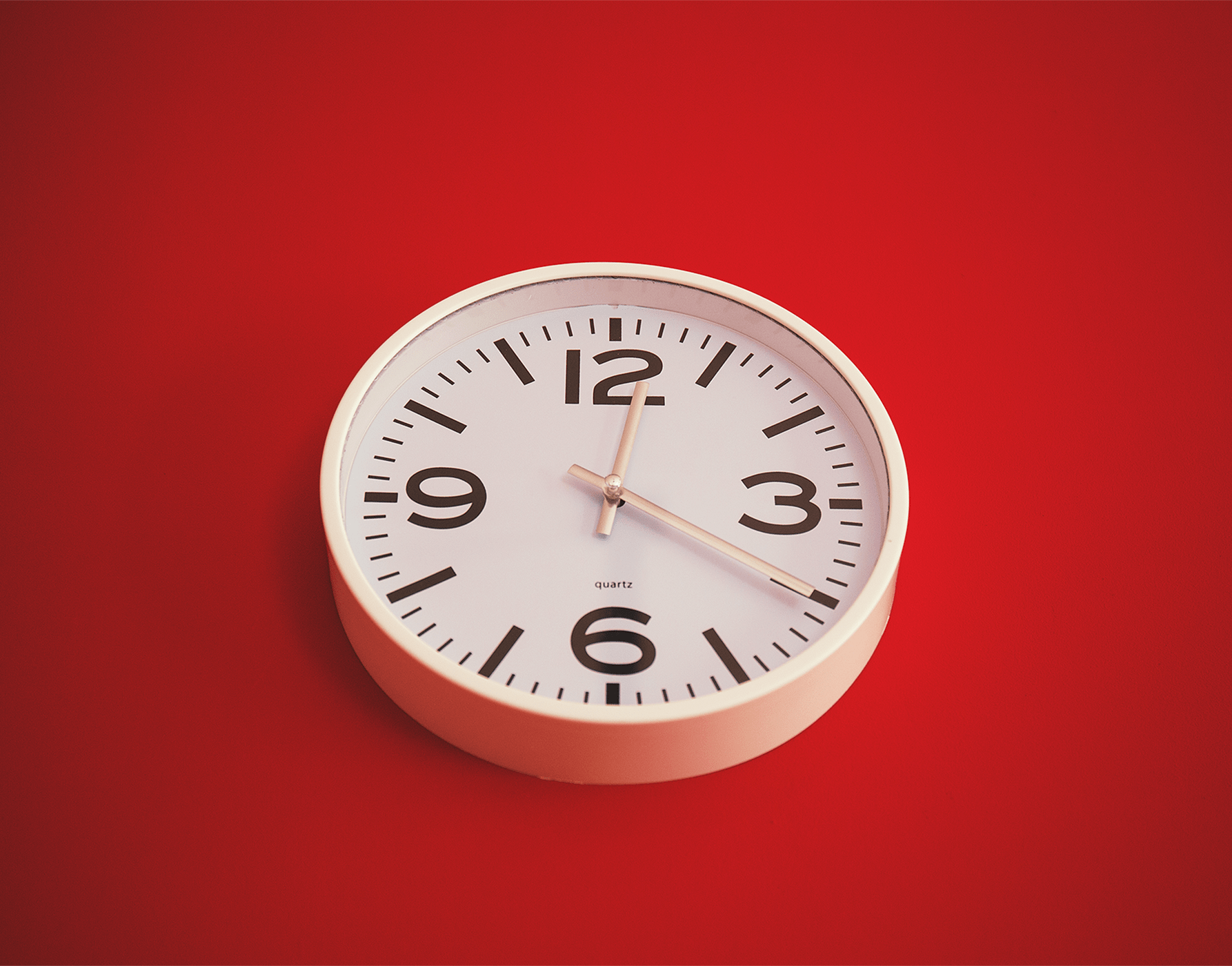Wall clock on red background